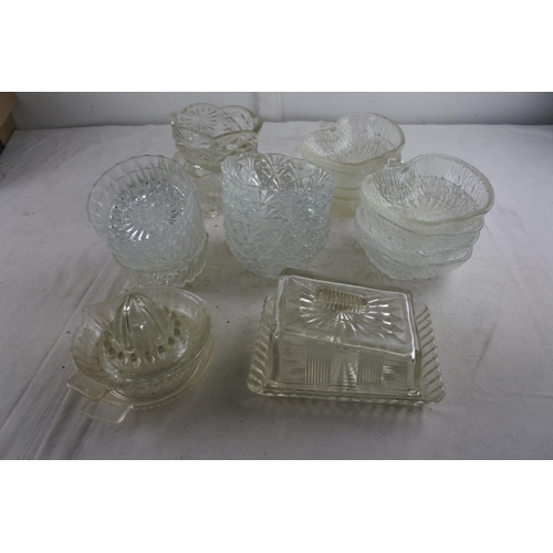 99 - An assortment of vintage glassware to include a butter dish, 'apple' sundae dishes and more.