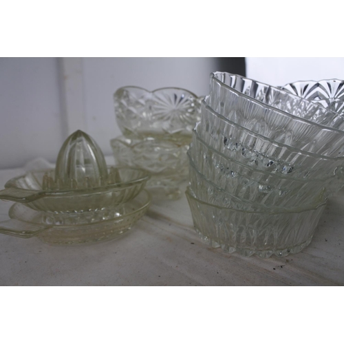 99 - An assortment of vintage glassware to include a butter dish, 'apple' sundae dishes and more.