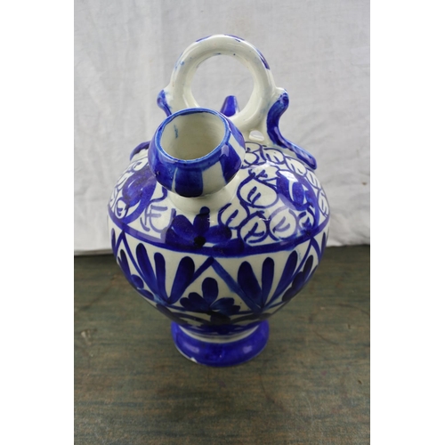 276 - A blue and white patterned flagon.