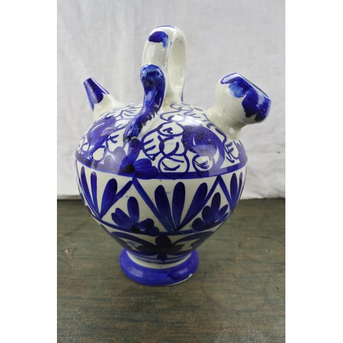 276 - A blue and white patterned flagon.