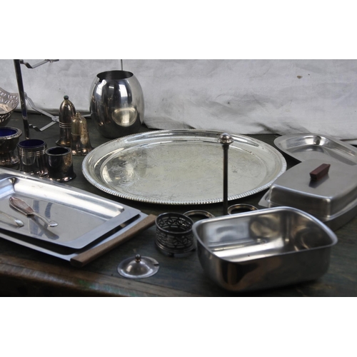 294 - A large assortment of stainless steel and silver plate ware.