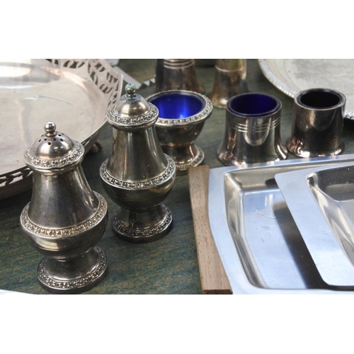 294 - A large assortment of stainless steel and silver plate ware.