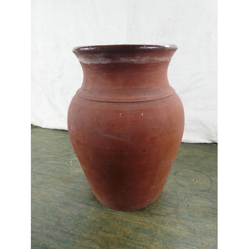 107 - A large terracotta glazed jar, 26cm tall.