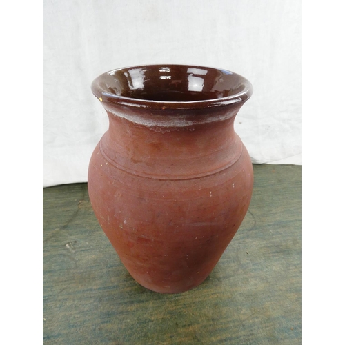 107 - A large terracotta glazed jar, 26cm tall.