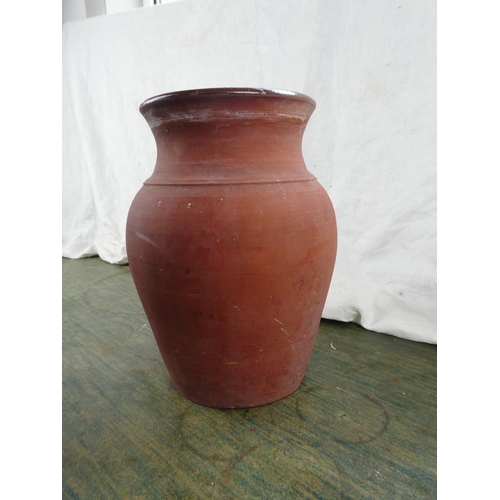 107 - A large terracotta glazed jar, 26cm tall.