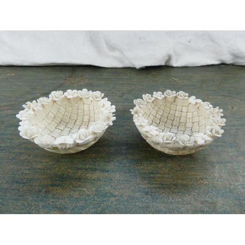 111 - An antique pair of Belleek pottery three strand baskets. (a/f)