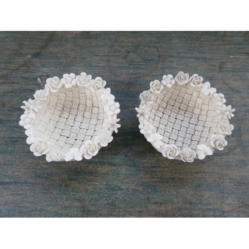 111 - An antique pair of Belleek pottery three strand baskets. (a/f)