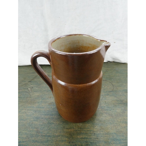 114 - An antique stoneware jug.