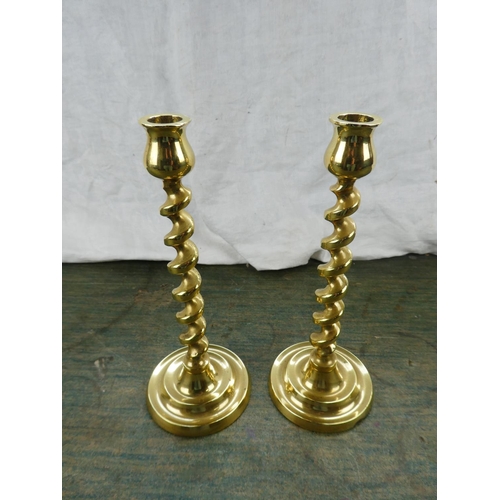 135 - A pair of twisted brass candlesticks.