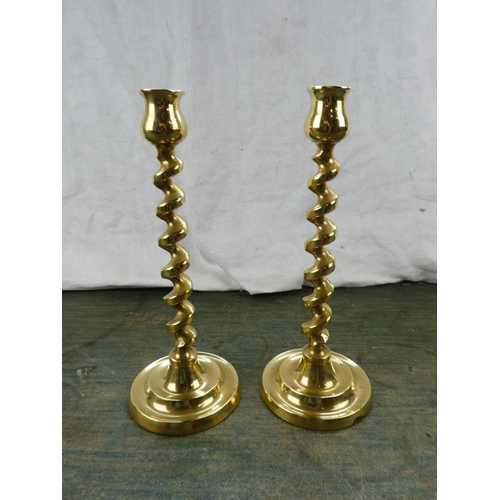 135 - A pair of twisted brass candlesticks.