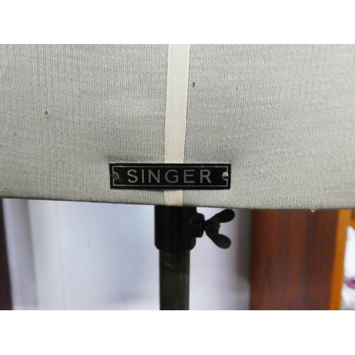 169 - A vintage Singer tailors dummy on a metal stand.