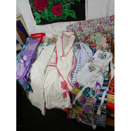 174 - An assortment of vintage linen tea towels and aprons.