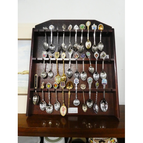 186 - A lot of souvenir spoons in a presentation wooden rack.