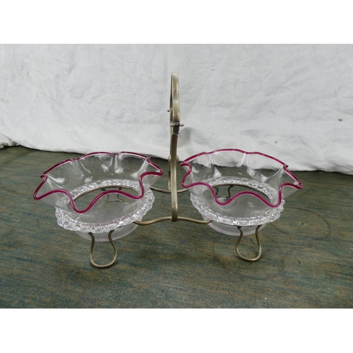 191 - A pair of antique glass dishes in a silver plated holder.