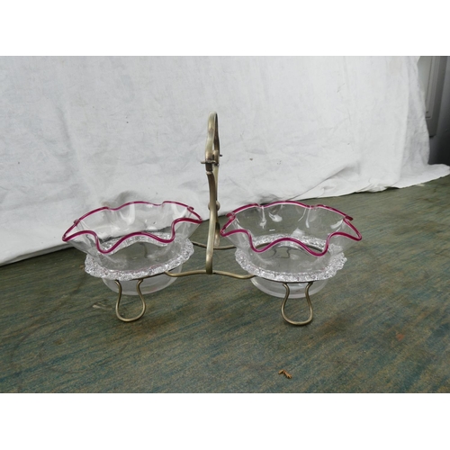 191 - A pair of antique glass dishes in a silver plated holder.