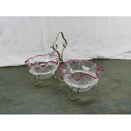 191 - A pair of antique glass dishes in a silver plated holder.