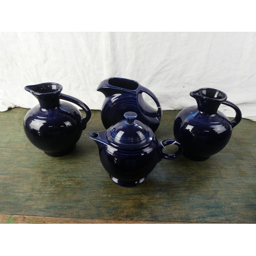 311 - A set of 4 vintage blue 'Fiesta' ware jugs (1 a/f)