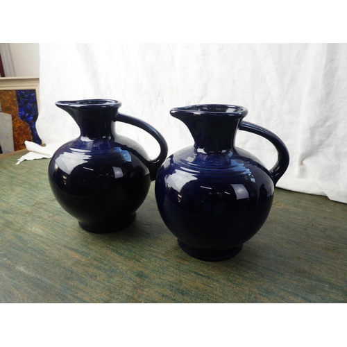 311 - A set of 4 vintage blue 'Fiesta' ware jugs (1 a/f)