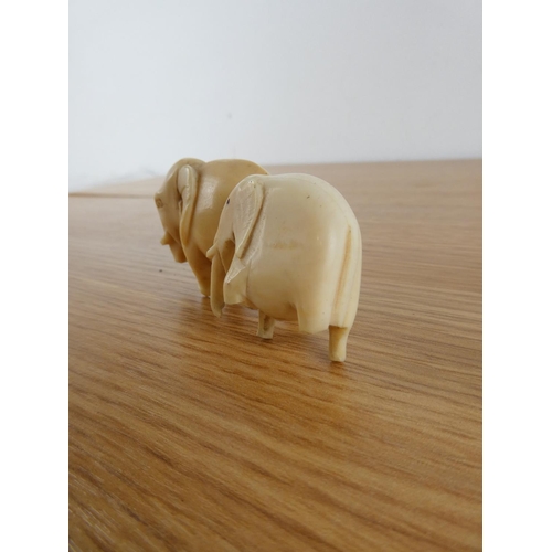 355 - Two antique hand carved bone elephants.