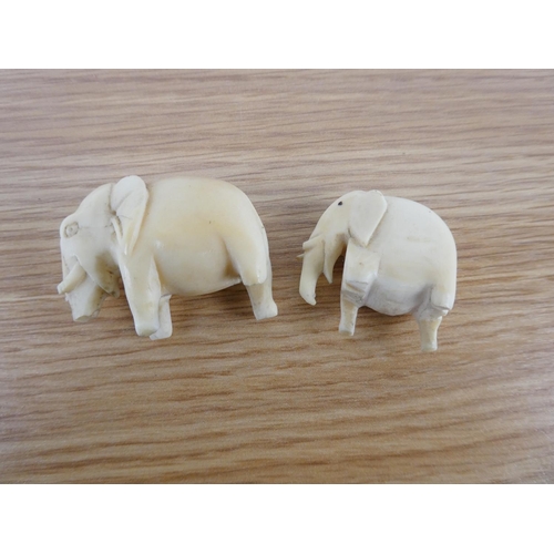 355 - Two antique hand carved bone elephants.