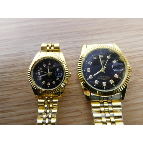 358 - A Dedima ladies and gents wrist watch set.