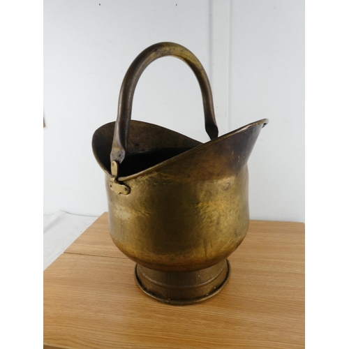 378 - An antique brass helmet shaped coal bucket.