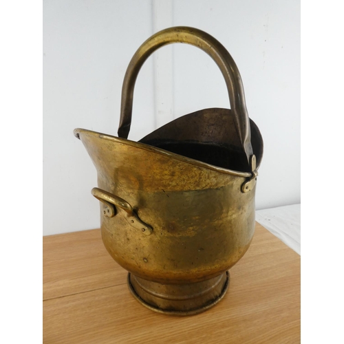 378 - An antique brass helmet shaped coal bucket.