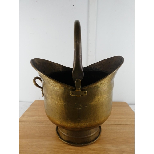 378 - An antique brass helmet shaped coal bucket.