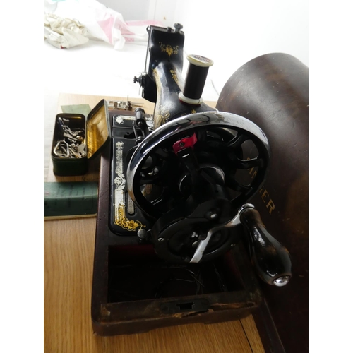 381 - A vintage Singer Sewing machine and case.