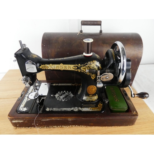 381 - A vintage Singer Sewing machine and case.