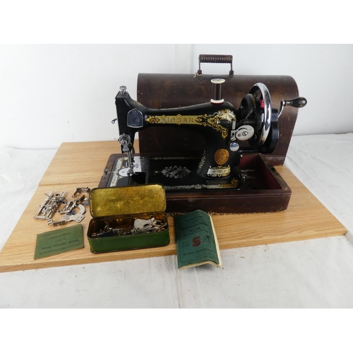 381 - A vintage Singer Sewing machine and case.