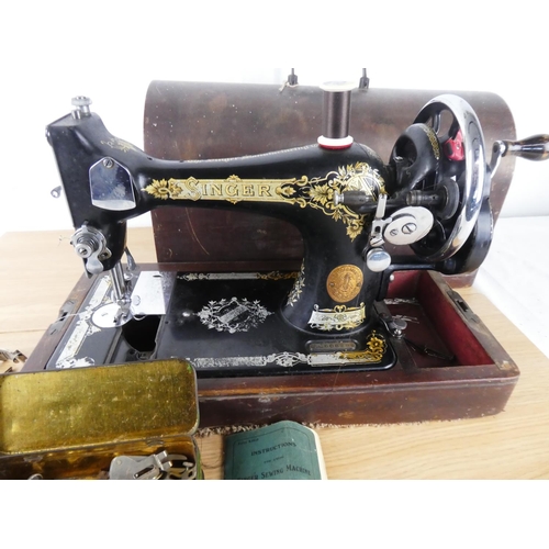 381 - A vintage Singer Sewing machine and case.