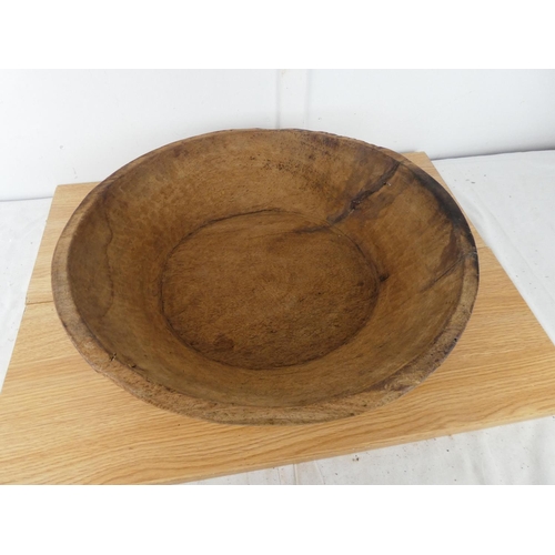 386 - A large antique wooden dairy bowl, measuring 50cm wide and 12cm tall.