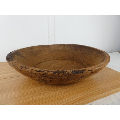 386 - A large antique wooden dairy bowl, measuring 50cm wide and 12cm tall.