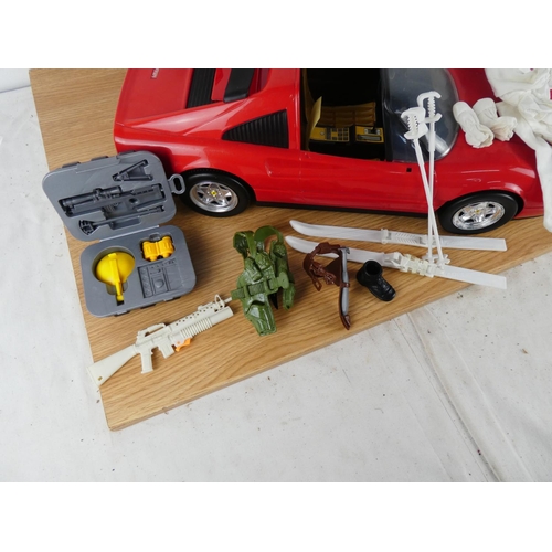 387 - A Ferrari toy car and Action Man figure and more.