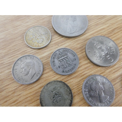 396 - An assorted lot of coinage to include six pence coins, a half crown and more.