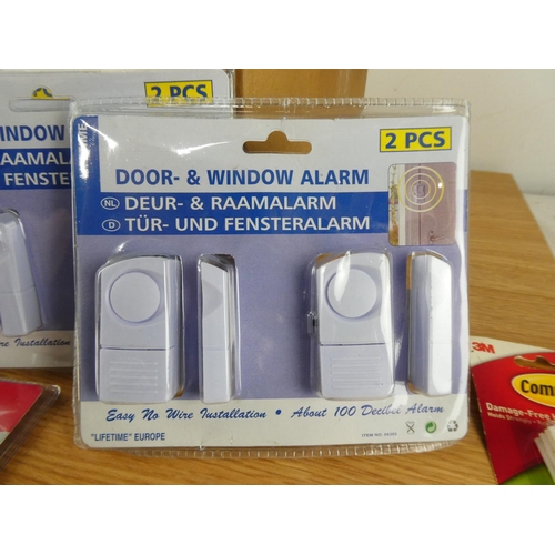 416 - A box of new door and window alarms.