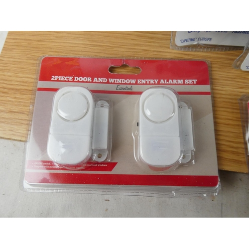 416 - A box of new door and window alarms.