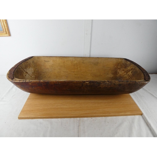 428 - A large antique dough bowl, measuring 90cm x 38cm x 18cm.