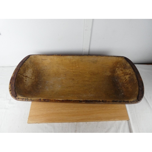 428 - A large antique dough bowl, measuring 90cm x 38cm x 18cm.