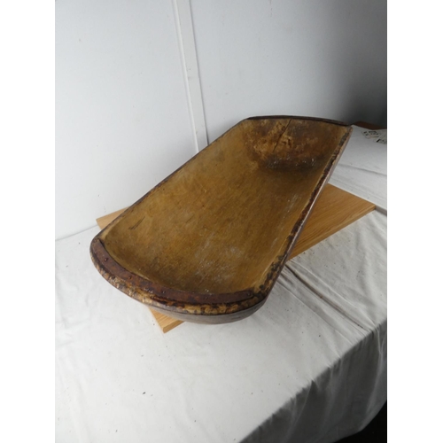 428 - A large antique dough bowl, measuring 90cm x 38cm x 18cm.