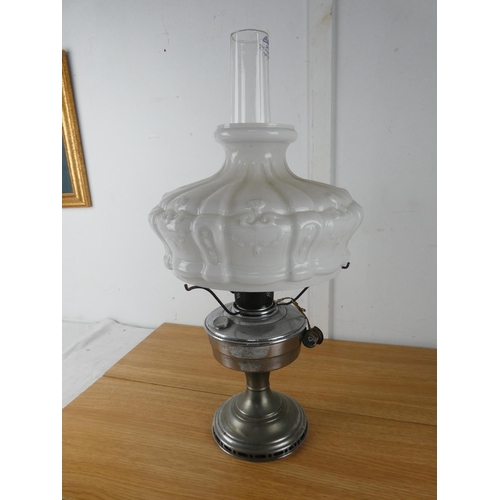 434 - A vintage metal paraffin oil lamp, and milk glass shade.