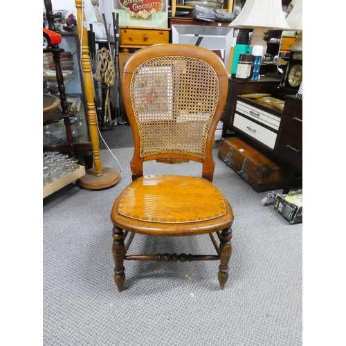 439 - A wooden chair with cane back detail.