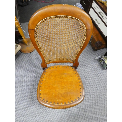 439 - A wooden chair with cane back detail.