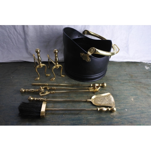 489 - A small set of brass fire irons and dogs and a coal bucket.