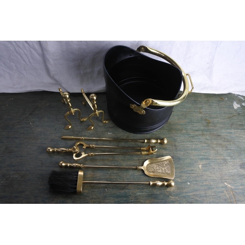 489 - A small set of brass fire irons and dogs and a coal bucket.