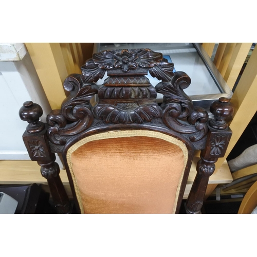 527 - A stunning antique oak framed armchair with highly decorative carved detail.