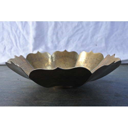 536 - A decorative brass bowl.