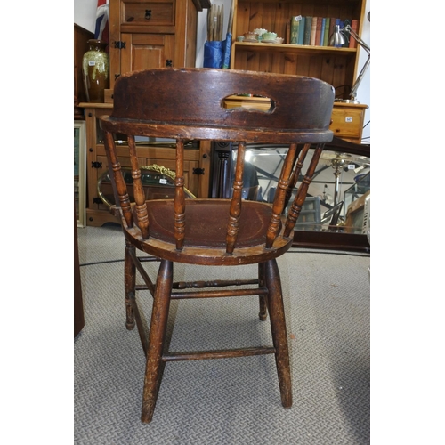 538 - A stunning antique oak smokers fireside chair.