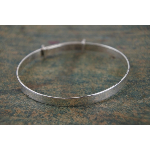 594 - A child's silver identity bangle.